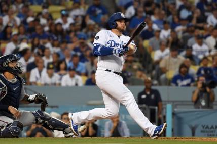 Aug 10, 2022; Los Angeles, California, USA; Los Angeles Dodgers third baseman Max Muncy (13) hits a solo home run in the second inning against the Minnesota Twins at Dodger Stadium. Mandatory Credit: Richard Mackson-USA TODAY Sports