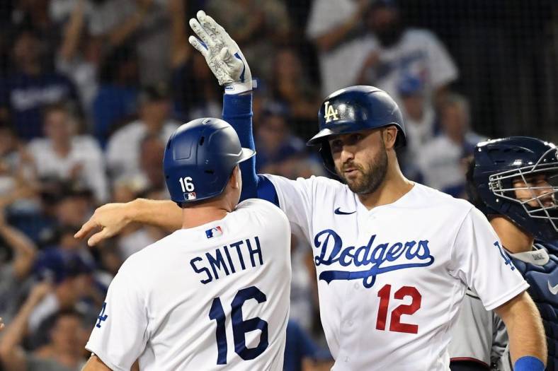 Aug 10, 2022; Los Angeles, California, USA; Los Angeles Dodgers right fielder Joey Gallo (12) celebrates with catcher Will Smith (16) after hitting a three run home run in the seventh inning against the Minnesota Twins at Dodger Stadium. Mandatory Credit: Richard Mackson-USA TODAY Sports