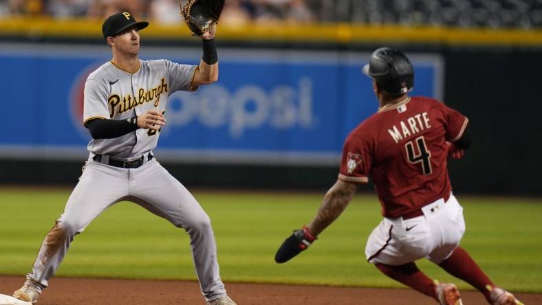 Aug 10, 2022; Phoenix, Ariz., USA; Arizona Diamondbacks' Ketel Marte slides in as Pittsburgh Pirates' Kevin Newman catches the ball for an out at Chase Field. Mandatory Credit: Joe Rondone-Arizona Republic

Mlb Pirates At Diamondbacks