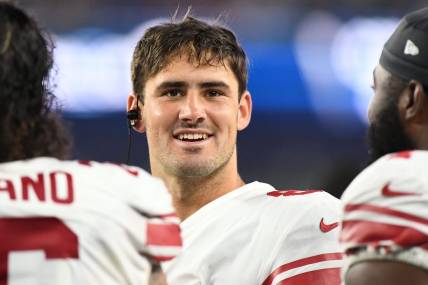 Aug 11, 2022; Foxborough, Massachusetts, USA; New York Giants quarterback Daniel Jones (8) talks with his teammates on the bench during the first half of a preseason game at Gillette Stadium. Mandatory Credit: Brian Fluharty-USA TODAY Sports