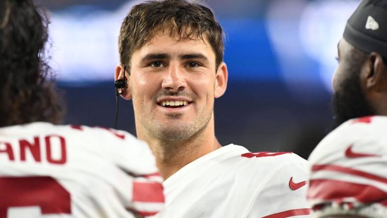 Aug 11, 2022; Foxborough, Massachusetts, USA; New York Giants quarterback Daniel Jones (8) talks with his teammates on the bench during the first half of a preseason game at Gillette Stadium. Mandatory Credit: Brian Fluharty-USA TODAY Sports