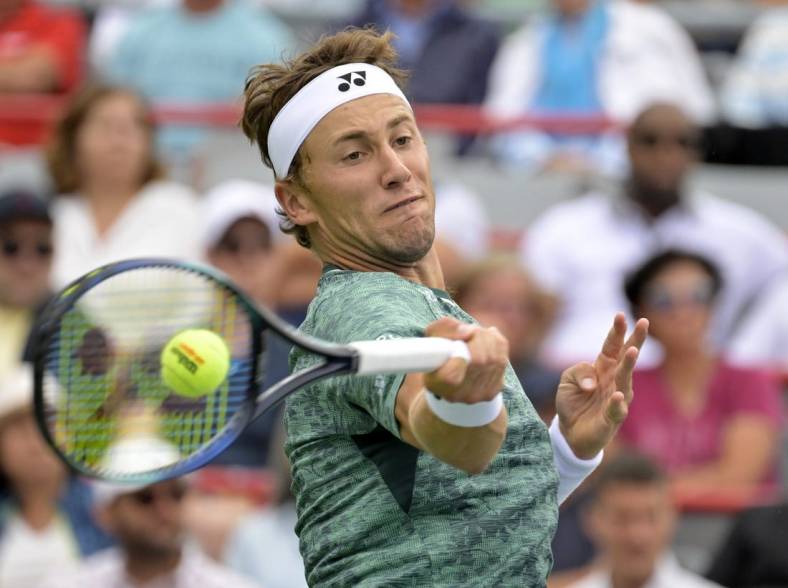 Aug 12, 2022; Montreal, QC, Canada; Casper Ruud (NOR) hits a forehand against Felix Auger-Aliassime (CAN) (not pictured) in quarterfinal play in the National Bank Open at IGA Stadium. Mandatory Credit: Eric Bolte-USA TODAY Sports