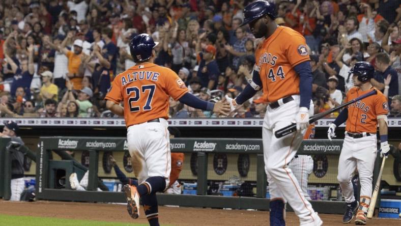 Aug 12, 2022; Houston, Texas, USA; Houston Astros designated hitter Yordan Alvarez (44) celebrates  second baseman Jose Altuve (27) run against the Oakland Athletics in the fifth inning at Minute Maid Park. Mandatory Credit: Thomas Shea-USA TODAY Sports