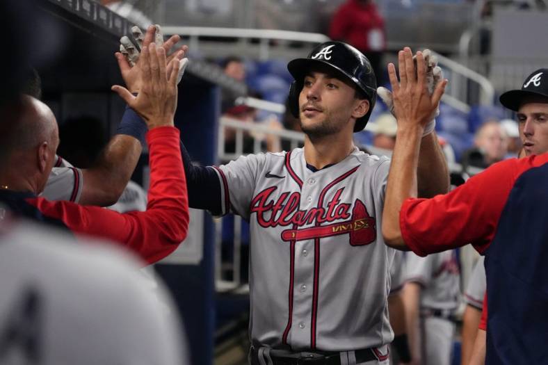 Aug 13, 2022; Miami, Florida, USA; Atlanta Braves first baseman Matt Olson (28) celebrates in the dugout with teammates after hitting a solo home run in the fifth inning against the Miami Marlins at loanDepot park. Mandatory Credit: Jasen Vinlove-USA TODAY Sports