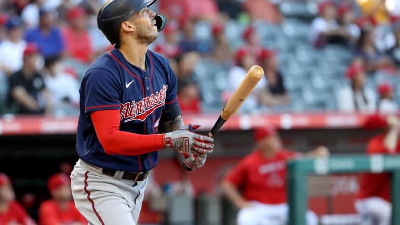 Aug 13, 2022; Anaheim, California, USA;  Minnesota Twins shortstop Carlos Correa (4) hits a home run in the first inning against the Los Angeles Angels at Angel Stadium. Mandatory Credit: Kiyoshi Mio-USA TODAY Sports