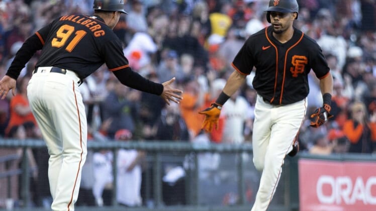 Aug 13, 2022; San Francisco, California, USA; San Francisco Giants designated hitter LaMonte Wade Jr. (right) celebrates with third base coach Mark Hallberg (91) after hitting a solo home run against the Pittsburgh Pirates in the third inning at Oracle Park. Mandatory Credit: D. Ross Cameron-USA TODAY Sports