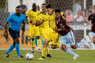 Aug 13, 2022; Commerce City, Colorado, USA; Columbus Crew SC midfielder Lucas Zelarrayan (10) and Colorado Rapids midfielder Bryan Acosta (21) battle for the ball in the first half at Dick's Sporting Goods Park. Mandatory Credit: Isaiah J. Downing-USA TODAY Sports