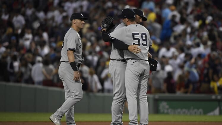 Aug 13, 2022; Boston, Massachusetts, USA;  New York Yankees relief pitcher Scott Effross (59) is congratulated by first baseman Anthony Rizzo (48) after defeating the Boston Red Sox at Fenway Park. Mandatory Credit: Bob DeChiara-USA TODAY Sports