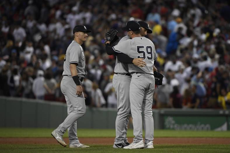 Aug 13, 2022; Boston, Massachusetts, USA;  New York Yankees relief pitcher Scott Effross (59) is congratulated by first baseman Anthony Rizzo (48) after defeating the Boston Red Sox at Fenway Park. Mandatory Credit: Bob DeChiara-USA TODAY Sports