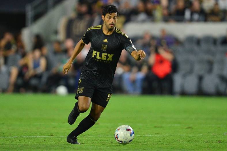 Aug 13, 2022; Los Angeles, California, USA; Los Angeles FC forward Carlos Vela (10) moves the ball against Charlotte FC during the second half at Banc of California Stadium. Mandatory Credit: Gary A. Vasquez-USA TODAY Sports