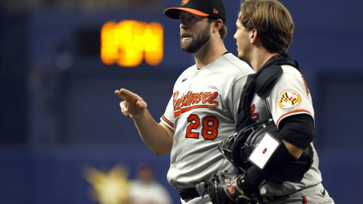 Aug 14, 2022; St. Petersburg, Florida, USA;Baltimore Orioles starting pitcher Jordan Lyles (28) and catcher Adley Rutschman (35) talk against the Tampa Bay Rays at the end of the first inning at Tropicana Field. Mandatory Credit: Kim Klement-USA TODAY Sports
