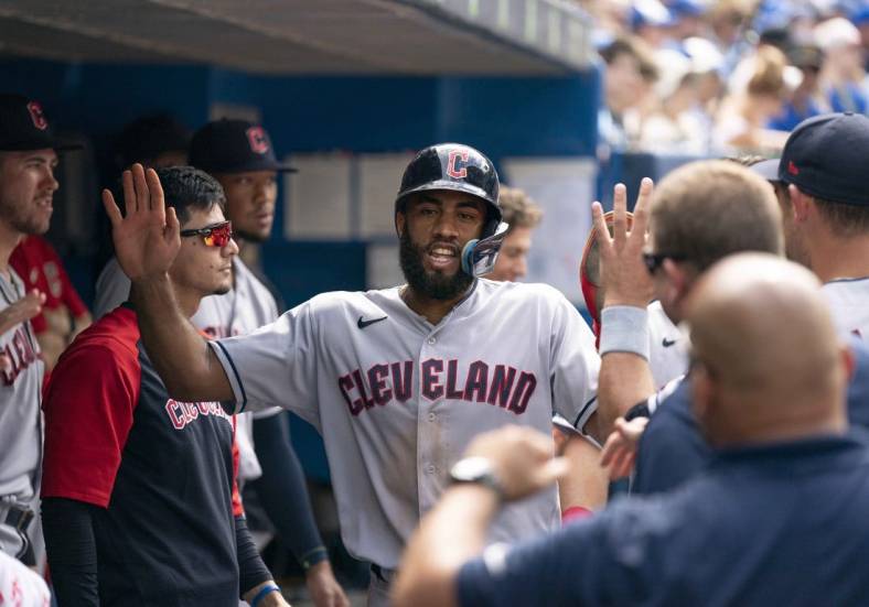Aug 14, 2022; Toronto, Ontario, CAN; Cleveland Guardians shortstop Amed Rosario (1) celebrates in the dugout after scoring a run against the Toronto Blue Jays during the fifth inning at Rogers Centre. Mandatory Credit: Nick Turchiaro-USA TODAY Sports