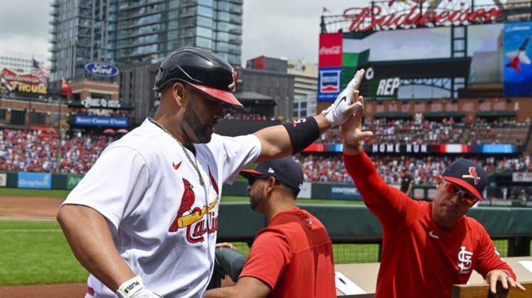 Aug 14, 2022; St. Louis, Missouri, USA;  St. Louis Cardinals designated hitter Albert Pujols (5) celebrates with bench coach Skip Schumaker (55) after hitting a solo home run against the Milwaukee Brewers during the second inning at Busch Stadium. Mandatory Credit: Jeff Curry-USA TODAY Sports