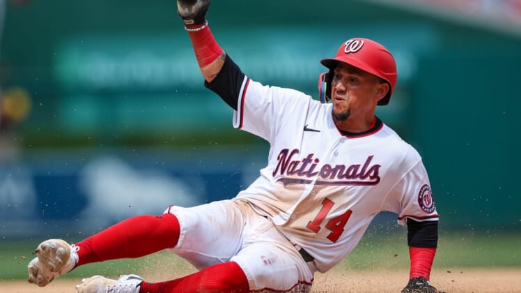 Aug 14, 2022; Washington, District of Columbia, USA; Washington Nationals shortstop Ildemaro Vargas (14) slides into third base and is returned during the eighth inning of the game against the San Diego Padres at Nationals Park. Mandatory Credit: Scott Taetsch-USA TODAY Sports