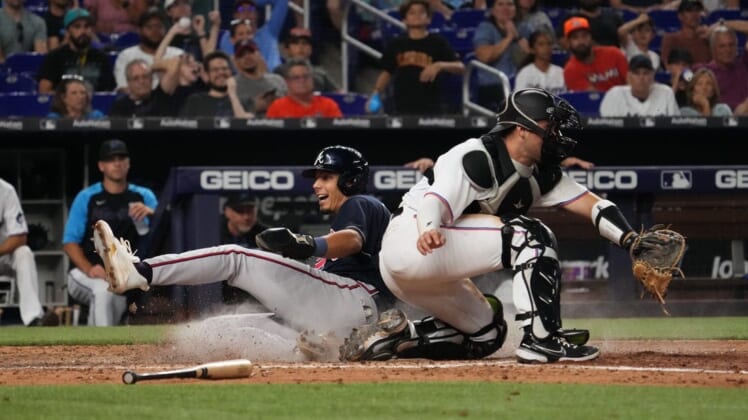 Aug 14, 2022; Miami, Florida, USA; Atlanta Braves second baseman Vaughn Grissom (18) scores a run behind Miami Marlins catcher Nick Fortes (54) on the single of catcher William Contreras (not pictured) in the ninth inning at loanDepot park. Mandatory Credit: Jasen Vinlove-USA TODAY Sports