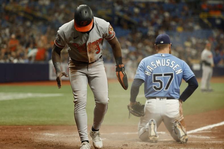 Aug 14, 2022; St. Petersburg, Florida, USA; Baltimore Orioles shortstop Jorge Mateo (3) scores a run on a wild pitch by Tampa Bay Rays starting pitcher Drew Rasmussen (57) during the ninth inning at Tropicana Field. Mandatory Credit: Kim Klement-USA TODAY Sports