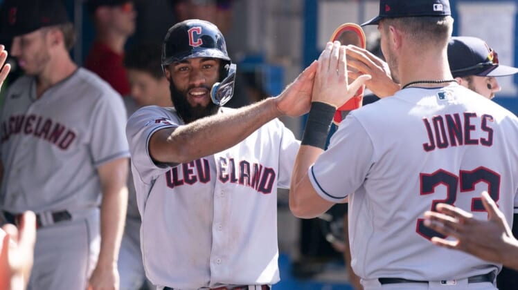 Aug 14, 2022; Toronto, Ontario, CAN; Cleveland Guardians shortstop Amed Rosario (1) celebrates in the dugout after scoring a run against the Toronto Blue Jays during the ninth inning at Rogers Centre. Mandatory Credit: Nick Turchiaro-USA TODAY Sports