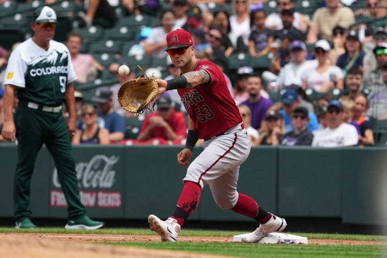 Aug 14, 2022; Denver, Colorado, USA; Arizona Diamondbacks first baseman Christian Walker (53) fields the ball in the fourth inning against the Colorado Rockies at Coors Field. Mandatory Credit: Ron Chenoy-USA TODAY Sports