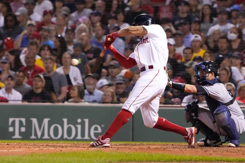 Aug 14, 2022; Boston, Massachusetts, USA; Boston Red Sox left fielder Tommy Pham (22) hits a single against the New York Yankees during the sixth inning at Fenway Park. Mandatory Credit: Gregory Fisher-USA TODAY Sports