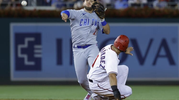 Aug 15, 2022; Washington, District of Columbia, USA; Chicago Cubs second baseman Nick Madrigal (1) attempts to turn a double play from second base ahead of the slide of Washington Nationals second baseman Cesar Hernandez (1) during the fifth inning at Nationals Park. Mandatory Credit: Geoff Burke-USA TODAY Sports