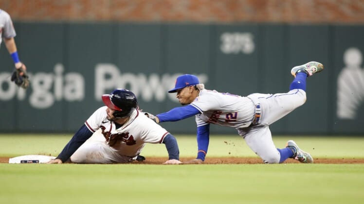 Aug 15, 2022; Atlanta, Georgia, USA; New York Mets shortstop Francisco Lindor (12) tags out Atlanta Braves catcher Travis d'Arnaud (16) at second base in the second inning at Truist Park. Mandatory Credit: Brett Davis-USA TODAY Sports