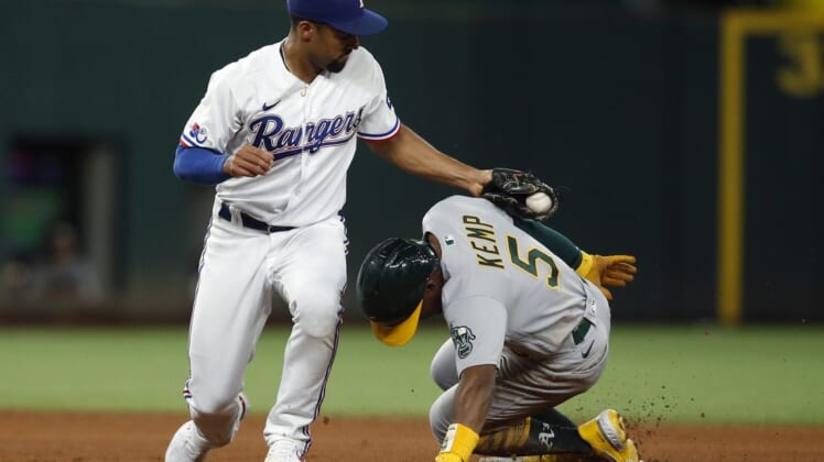 Aug 15, 2022; Arlington, Texas, USA; Oakland Athletics left fielder Tony Kemp (5) steals second base in the fifth inning as Texas Rangers second baseman Marcus Semien (2) applies the tag at Globe Life Field. Mandatory Credit: Tim Heitman-USA TODAY Sports