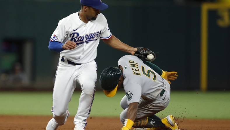 Aug 15, 2022; Arlington, Texas, USA; Oakland Athletics left fielder Tony Kemp (5) steals second base in the fifth inning as Texas Rangers second baseman Marcus Semien (2) applies the tag at Globe Life Field. Mandatory Credit: Tim Heitman-USA TODAY Sports