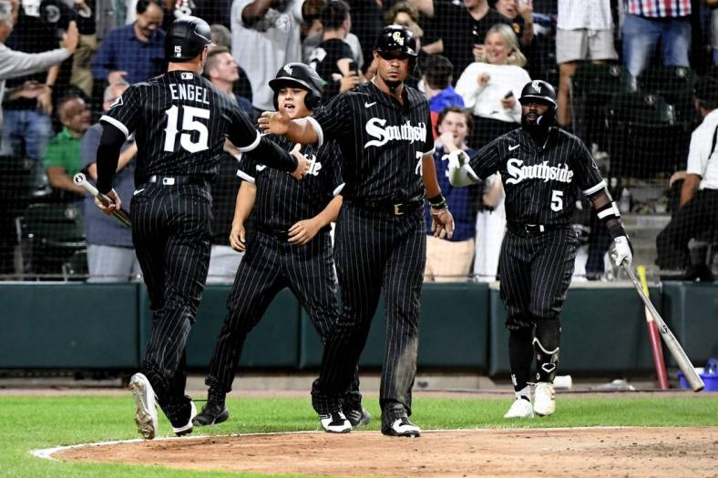 Aug 15, 2022; Chicago, Illinois, USA;  Chicago White Sox first baseman Jose Abreu (79) high fives Chicago White Sox center fielder Adam Engel (15)after they score against the Houston Astros during the eighth inning at Guaranteed Rate Field. Mandatory Credit: Matt Marton-USA TODAY Sports