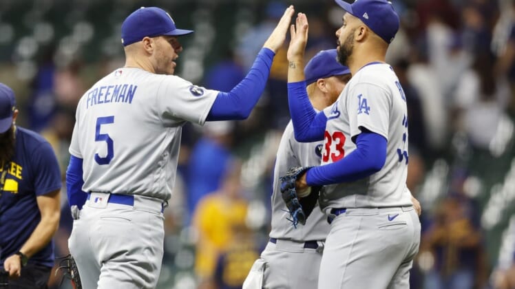 Aug 15, 2022; Milwaukee, Wisconsin, USA;  Los Angeles Dodgers first baseman Freddie Freeman (5) high fives pitcher David Price (33) following the game against the Milwaukee Brewers at American Family Field. Mandatory Credit: Jeff Hanisch-USA TODAY Sports