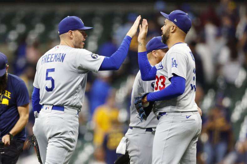 Aug 15, 2022; Milwaukee, Wisconsin, USA;  Los Angeles Dodgers first baseman Freddie Freeman (5) high fives pitcher David Price (33) following the game against the Milwaukee Brewers at American Family Field. Mandatory Credit: Jeff Hanisch-USA TODAY Sports
