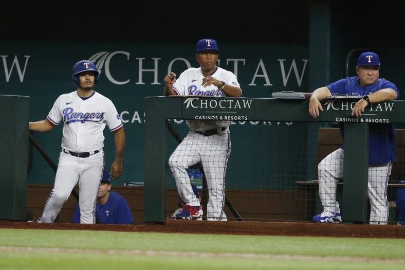 Aug 15, 2022; Arlington, Texas, USA; Texas Rangers interim manager Tony Beasley (27) watches the game in the eighth inning against the Oakland Athletics at Globe Life Field. Mandatory Credit: Tim Heitman-USA TODAY Sports