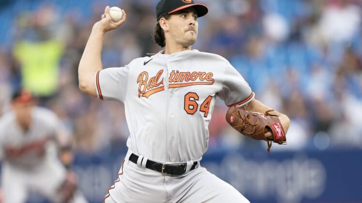 Aug 16, 2022; Toronto, Ontario, CAN; Baltimore Orioles starting pitcher Dean Kremer (64) throws a pitch against the Toronto Blue Jays during the first inning at Rogers Centre. Mandatory Credit: Nick Turchiaro-USA TODAY Sports