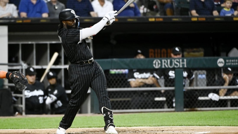 Aug 16, 2022; Chicago, Illinois, USA; Chicago White Sox second baseman Josh Harrison (5) hits an RBI single against the Houston Astros during the second inning at Guaranteed Rate Field. Mandatory Credit: Matt Marton-USA TODAY Sports