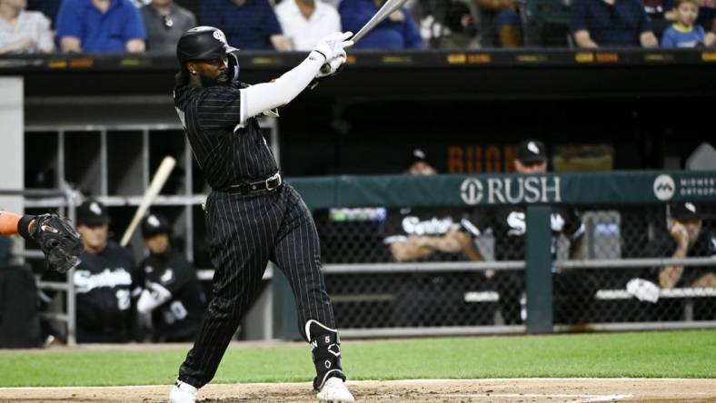 Aug 16, 2022; Chicago, Illinois, USA; Chicago White Sox second baseman Josh Harrison (5) hits an RBI single against the Houston Astros during the second inning at Guaranteed Rate Field. Mandatory Credit: Matt Marton-USA TODAY Sports