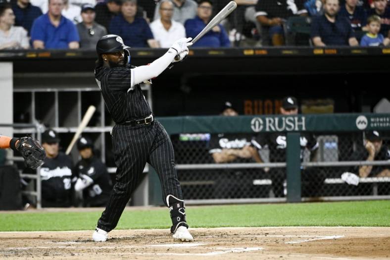 Aug 16, 2022; Chicago, Illinois, USA; Chicago White Sox second baseman Josh Harrison (5) hits an RBI single against the Houston Astros during the second inning at Guaranteed Rate Field. Mandatory Credit: Matt Marton-USA TODAY Sports
