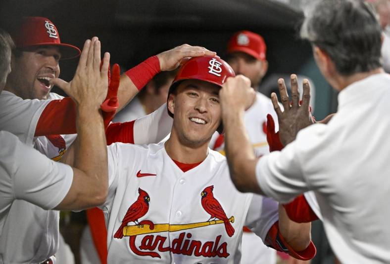 Aug 16, 2022; St. Louis, Missouri, USA;  St. Louis Cardinals second baseman Tommy Edman (19) is congratulated y teammates after hitting a solo home run against the Colorado Rockies during the fourth inning at Busch Stadium. Mandatory Credit: Jeff Curry-USA TODAY Sports