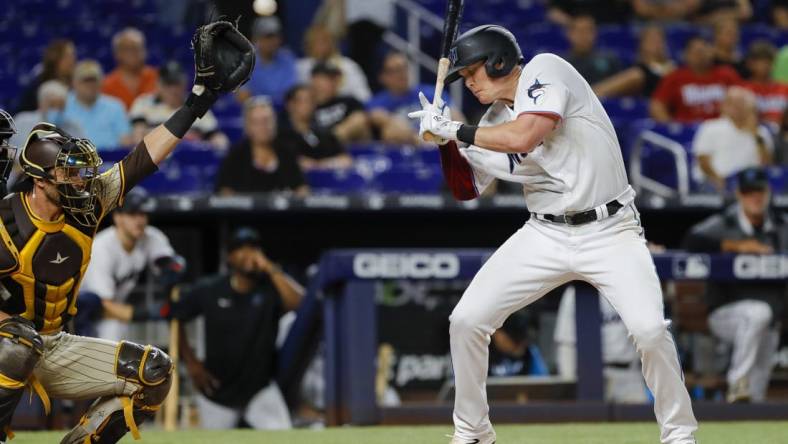 Aug 16, 2022; Miami, Florida, USA; Miami Marlins first baseman Garrett Cooper (26) reacts after getting hit by a pitch during the eighth inning against the San Diego Padres at loanDepot Park. Mandatory Credit: Sam Navarro-USA TODAY Sports