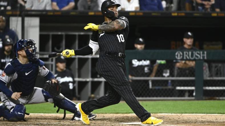 Aug 16, 2022; Chicago, Illinois, USA; Chicago White Sox third baseman Yoan Moncada (10) hits an RBI single against the Houston Astros during the eighth inning at Guaranteed Rate Field. Mandatory Credit: Matt Marton-USA TODAY Sports