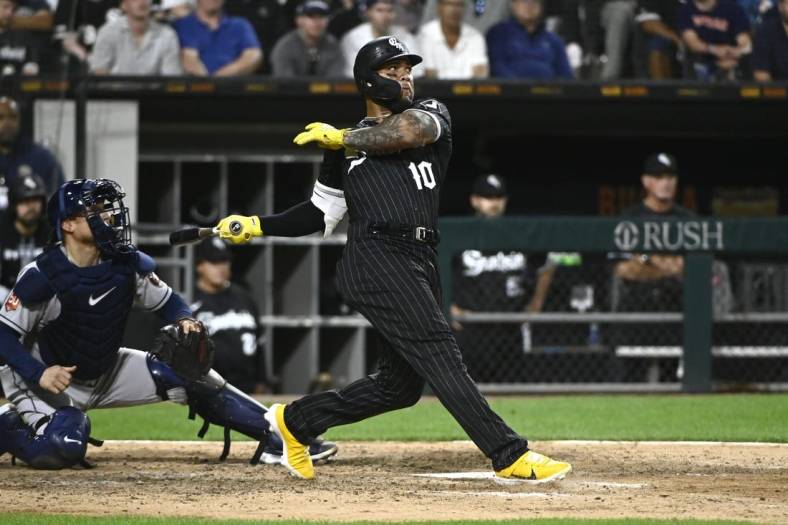 Aug 16, 2022; Chicago, Illinois, USA; Chicago White Sox third baseman Yoan Moncada (10) hits an RBI single against the Houston Astros during the eighth inning at Guaranteed Rate Field. Mandatory Credit: Matt Marton-USA TODAY Sports