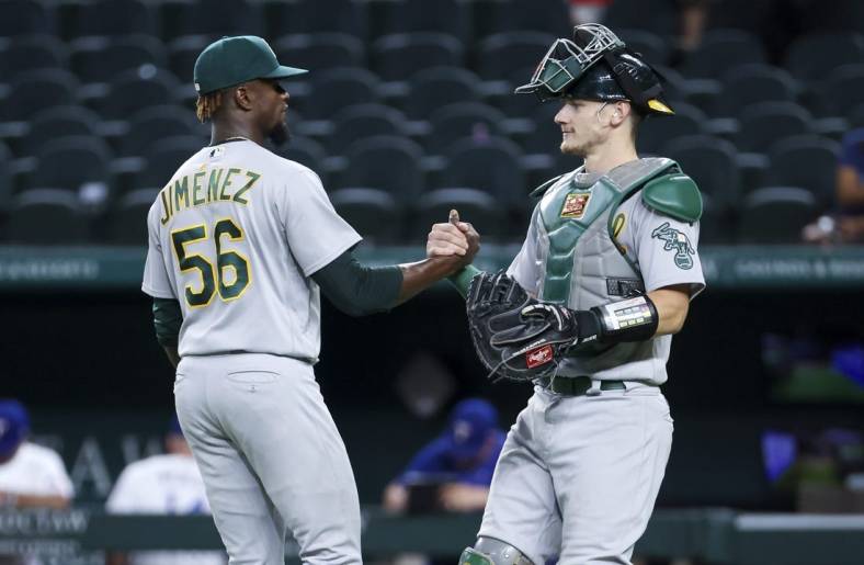 Aug 16, 2022; Arlington, Texas, USA;  Oakland Athletics relief pitcher Dany Jimenez (56) celebrates with Oakland Athletics catcher Sean Murphy (12) after the game against the Texas Rangers at Globe Life Field. Mandatory Credit: Kevin Jairaj-USA TODAY Sports