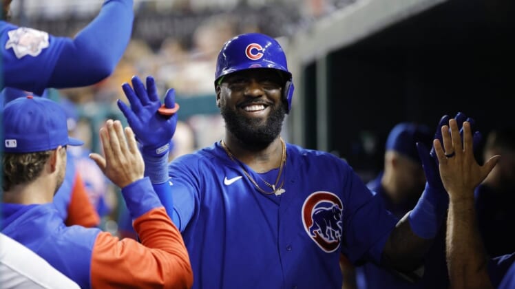 Aug 16, 2022; Washington, District of Columbia, USA; Chicago Cubs designated hitter Franmil Reyes (32) celebrates with teammates in the dugout after hitting a home run against the Washington Nationals during the sixth inning at Nationals Park. Mandatory Credit: Geoff Burke-USA TODAY Sports