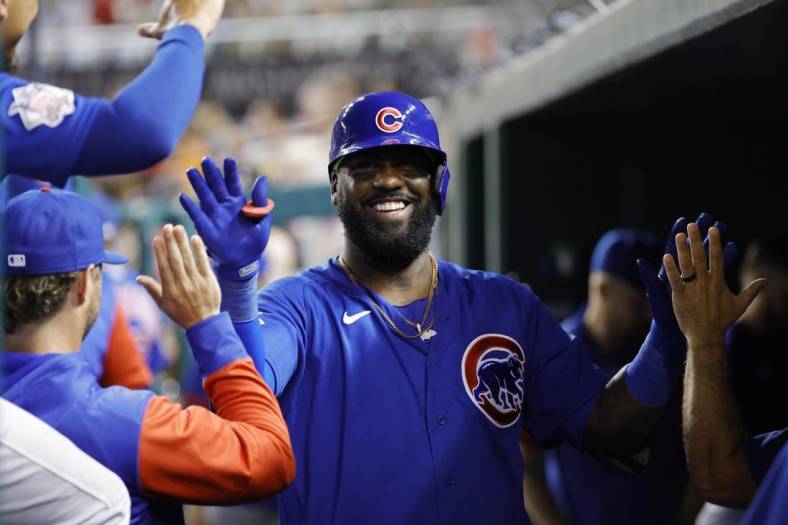 Aug 16, 2022; Washington, District of Columbia, USA; Chicago Cubs designated hitter Franmil Reyes (32) celebrates with teammates in the dugout after hitting a home run against the Washington Nationals during the sixth inning at Nationals Park. Mandatory Credit: Geoff Burke-USA TODAY Sports