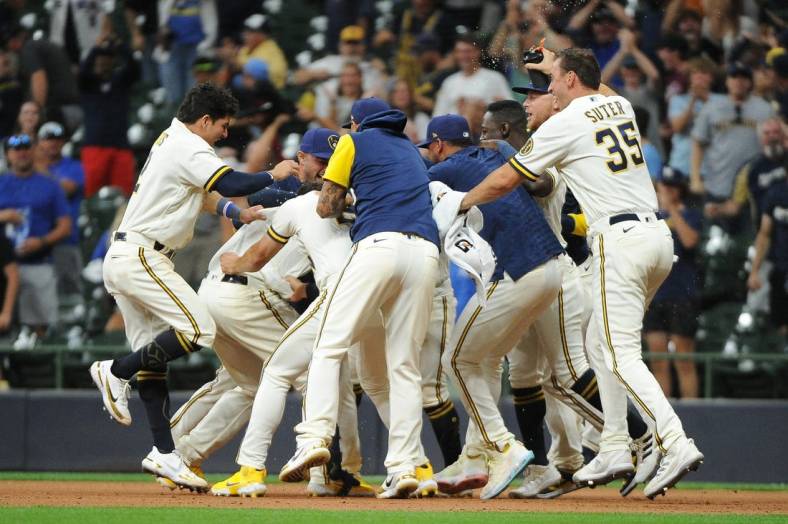 Aug 16, 2022; Milwaukee, Wisconsin, USA; The Milwaukee Brewers celebrate around catcher Victor Caratini (7) after a game winning hit against the Los Angeles Dodgers in the eleventh inning at American Family Field. Final Milwaukee Brewers 5, Los Angeles Dodgers 4. Mandatory Credit: Michael McLoone-USA TODAY Sports