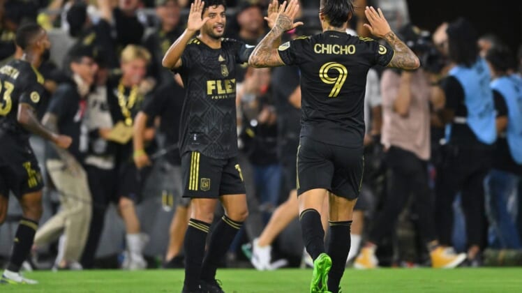 Aug 16, 2022; Los Angeles, California, USA; LAFC forward Carlos Vela (10) and forward Cristian Arango (9) high five after the combined assist to forward Kwadwo Opoku (not pictured) allowing him to score a goal in the second half at Banc of California Stadium. Mandatory Credit: Jayne Kamin-Oncea-USA TODAY Sports