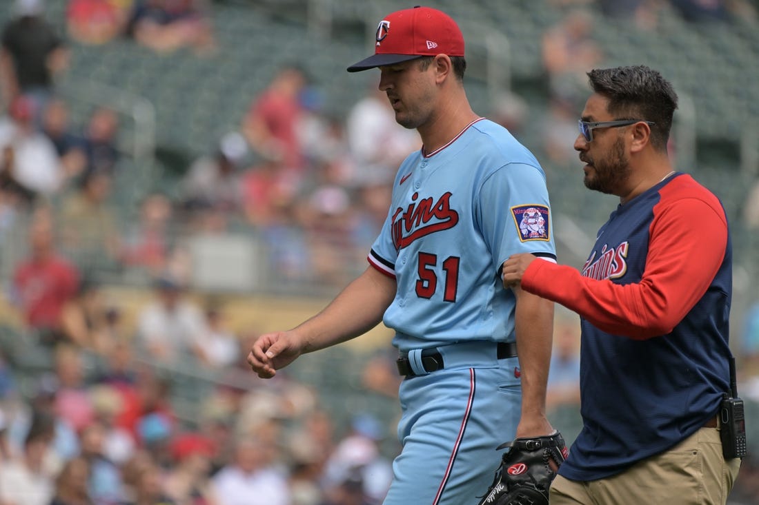 Aug 17, 2022; Minneapolis, Minnesota, USA; Minnesota Twins starting pitcher Tyler Mahle (51) comes off the field with the team trainer during the third inning against the Kansas City Royals at Target Field. Mandatory Credit: Jeffrey Becker-USA TODAY Sports