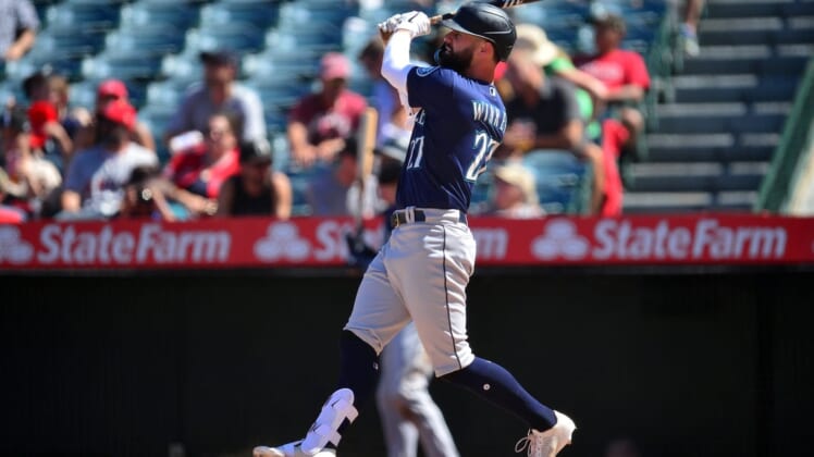 Aug 17, 2022; Anaheim, California, USA; Seattle Mariners designated hitter Jesse Winker (27) hits a two run home run against the Los Angeles Angels during the sixth inning at Angel Stadium. Mandatory Credit: Gary A. Vasquez-USA TODAY Sports