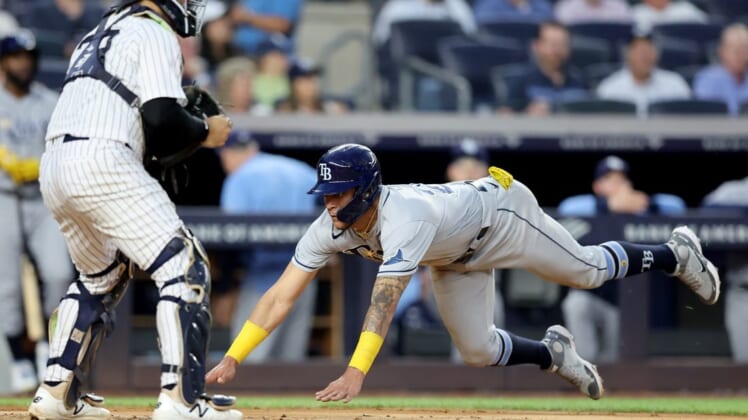 Aug 17, 2022; Bronx, New York, USA; Tampa Bay Rays center fielder Jose Siri (22) scores a run against New York Yankees catcher Jose Trevino (39) on a double by Rays third baseman Yandy Diaz (not pictured) during the third inning at Yankee Stadium. Mandatory Credit: Brad Penner-USA TODAY Sports