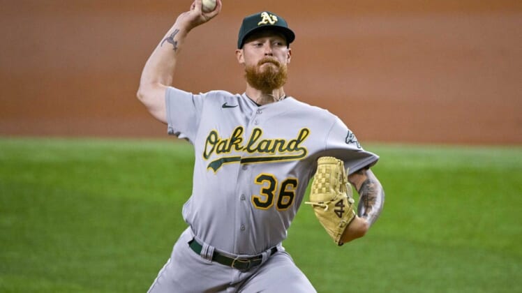 Aug 17, 2022; Arlington, Texas, USA; Oakland Athletics starting pitcher Adam Oller (36) pitches against the Texas Rangers during the first inning at Globe Life Field. Mandatory Credit: Jerome Miron-USA TODAY Sports