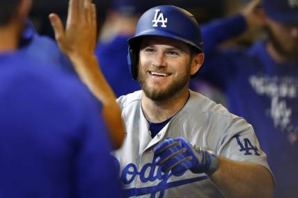 Aug 17, 2022; Milwaukee, Wisconsin, USA;  Los Angeles Dodgers third baseman Max Muncy (13) celebrates after hitting a home run during the seventh inning against the Milwaukee Brewers at American Family Field. Mandatory Credit: Jeff Hanisch-USA TODAY Sports