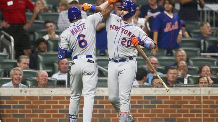 Aug 17, 2022; Atlanta, Georgia, USA; New York Mets right fielder Starling Marte (6) celebrates with first baseman Pete Alonso (20) after Marte s home run against the Atlanta Braves in the seventh inning at Truist Park. Mandatory Credit: Brett Davis-USA TODAY Sports